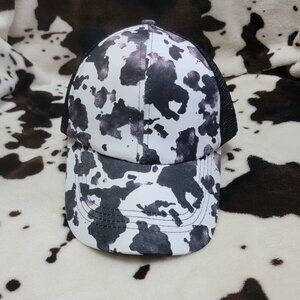 Black Cow Print Criss Cross Ponytail Hat
